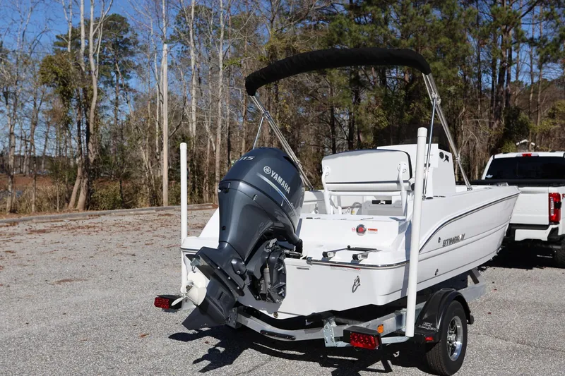 Slide: The Image of 2025 Stingray 173 CC boat with Yamaha outboard motor on trailer, parked outdoors. - 2