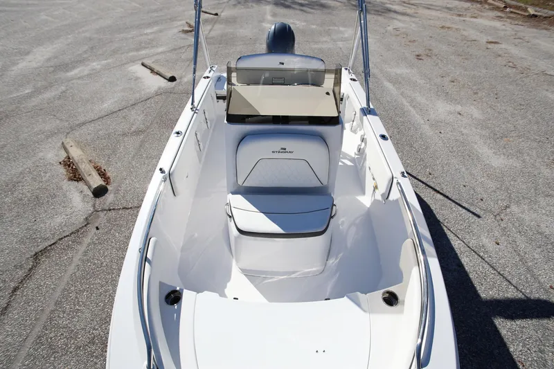Slide: The Image of 2025 Stingray 173 CC boat, white interior, parked on asphalt surface. - 26