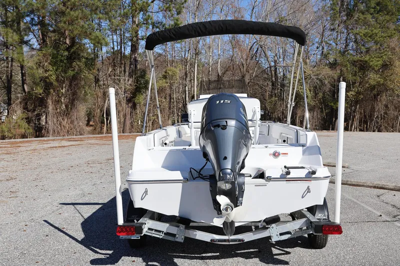 Slide: The Image of 2025 Stingray 173 CC boat with outboard motor, parked on a sunny day. - 3