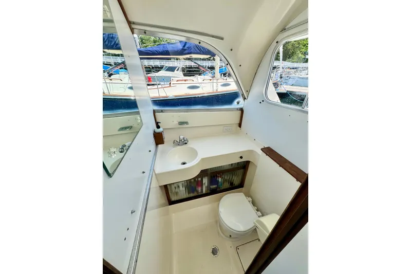 Slide: The Image of Interior of 1973 Bertram 31 Flybridge Cruiser bathroom with sink and toilet. - 6