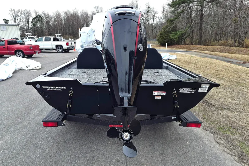 Slide: The Image of 2026 Tracker Pro Team 190 boat with outboard motor, parked outdoors. - 7