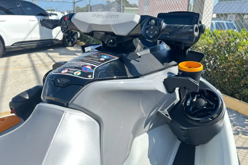 Slide: The Image of 2023 Sea-Doo FishPro Trophy 170, close-up of handlebars and controls in a parking lot. - 4