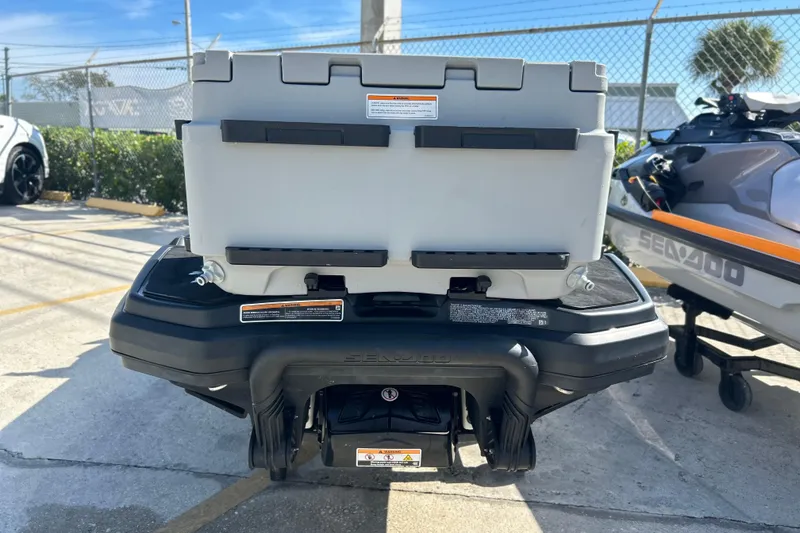 Slide: The Image of 2023 Sea-Doo FishPro Trophy 170 rear view with storage box in parking lot. - 6
