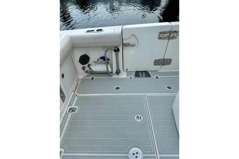 Slide: The Image of 2020 Boston Whaler 330 Outrage deck with storage and water access. - 19