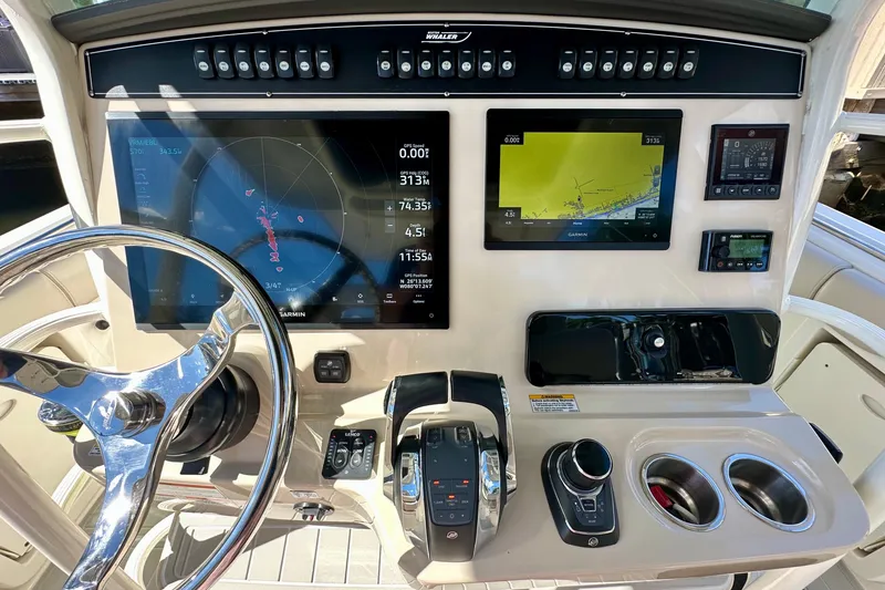 Slide: The Image of Control panel of 2020 Boston Whaler 330 Outrage with navigation screens and steering wheel. - 5