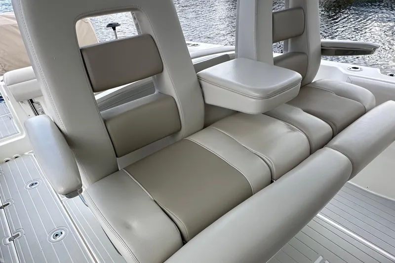 Slide: The Image of 2020 Boston Whaler 330 Outrage boat seating with armrests and cushioned backrests. - 6
