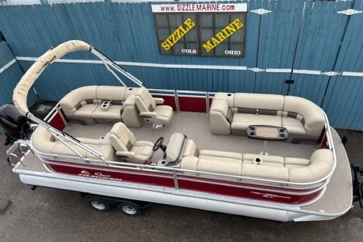The Image of 2025 Sun Tracker Party Barge 24 DLX pontoon boat with beige seating and red exterior. - 0