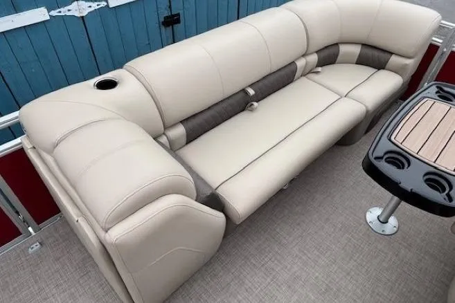 Slide: The Image of 2025 Sun Tracker Party Barge 24 DLX interior with beige seating and table. - 10