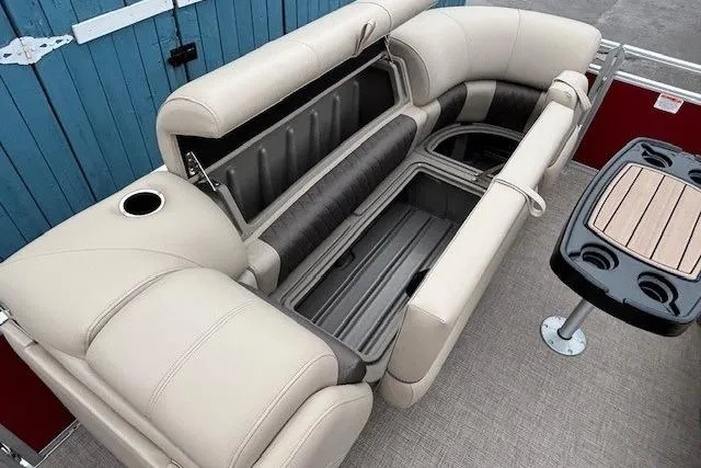 Slide: The Image of 2025 Sun Tracker Party Barge 24 DLX interior with beige seating and storage compartments. - 12