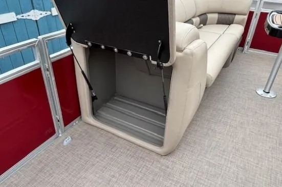 Slide: The Image of 2025 Sun Tracker Party Barge 24 DLX with open storage compartment and beige seating. - 13