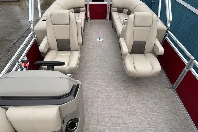 Slide: The Image of 2025 Sun Tracker Party Barge 24 DLX interior with beige seating and red accents. - 14