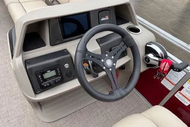 Slide: The Image of 2025 Sun Tracker Party Barge 24 DLX steering console with modern controls and dashboard. - 17