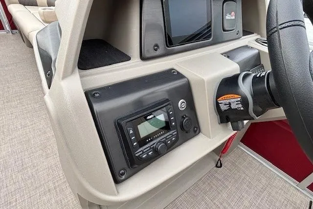 Slide: The Image of 2025 Sun Tracker Party Barge 24 DLX dashboard with modern controls and steering wheel. - 18