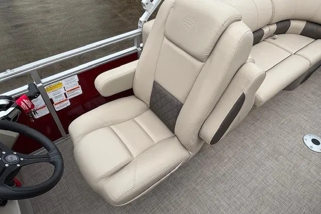 Slide: The Image of 2025 Sun Tracker Party Barge 24 DLX, luxurious beige seating, steering wheel detail. - 19
