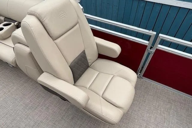 Slide: The Image of 2025 Sun Tracker Party Barge 24 DLX beige seat with armrests on pontoon boat. - 20