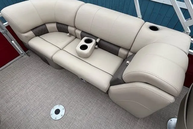 Slide: The Image of 2025 Sun Tracker Party Barge 24 DLX seating with cup holders and beige upholstery. - 22