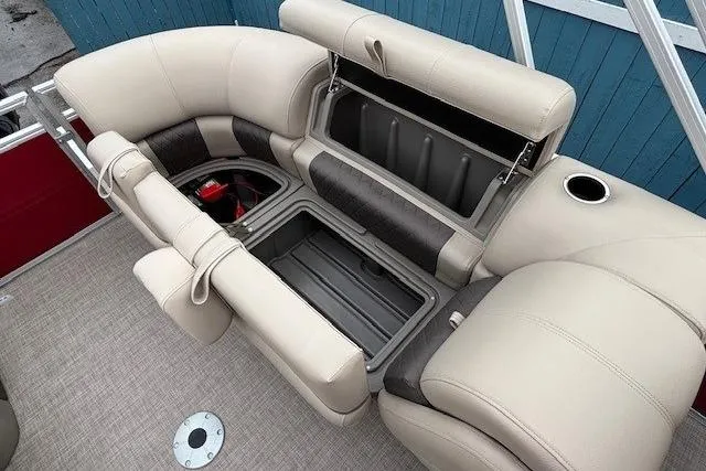 Slide: The Image of 2025 Sun Tracker Party Barge 24 DLX seating with storage compartments open. - 23