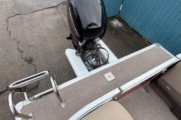 Slide: The Image of 2025 Sun Tracker Party Barge 24 DLX with outboard motor and deck view. - 28