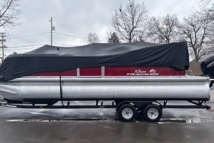 Slide: The Image of 2025 Sun Tracker Party Barge 24 DLX pontoon boat covered on a trailer. - 29