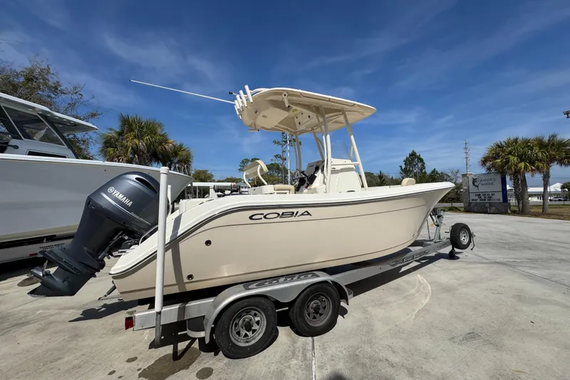 Slide: The Image of 2017 Cobia 220 Center Console boat on trailer, featuring Yamaha outboard motor. - 10