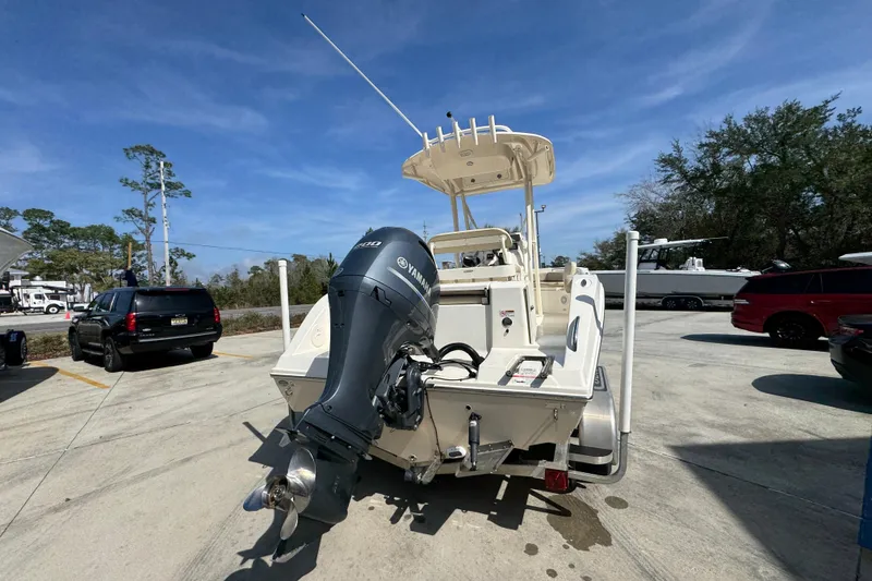 Slide: The Image of 2017 Cobia 220 Center Console boat with Yamaha outboard motor in parking lot. - 12