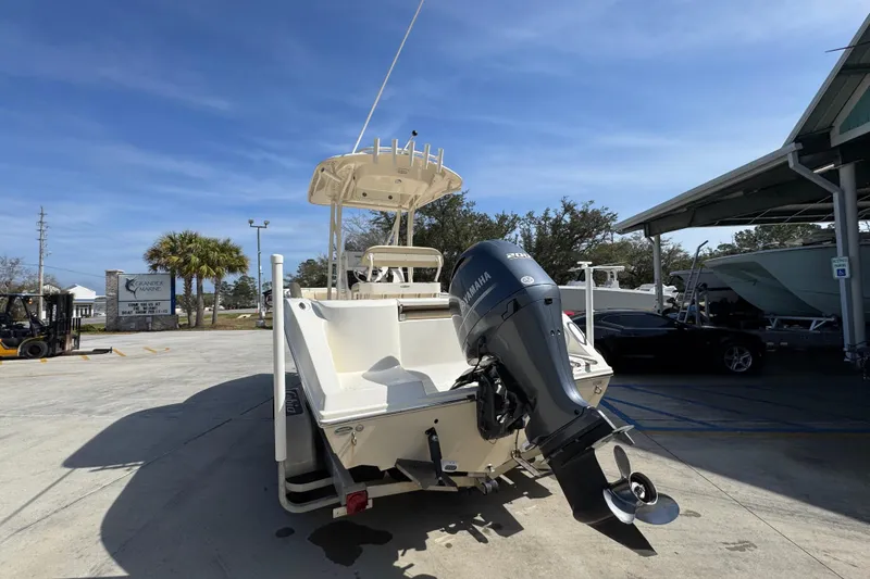 Slide: The Image of 2017 Cobia 220 Center Console boat with Yamaha outboard motor in a marina setting. - 14