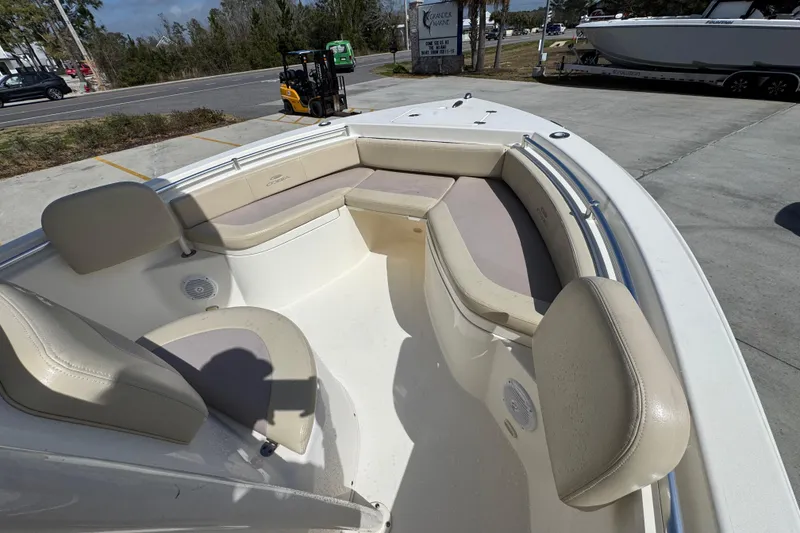 Slide: The Image of 2017 Cobia 220 Center Console boat with beige seating and spacious deck. - 17