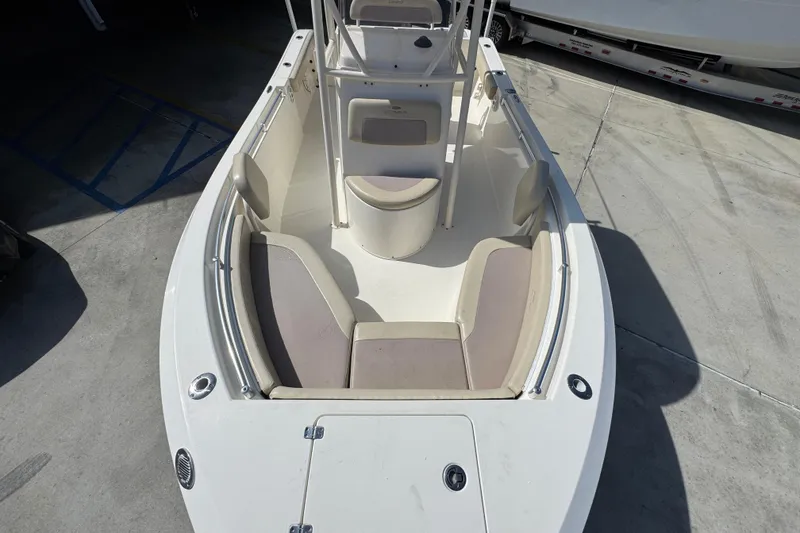 Slide: The Image of 2017 Cobia 220 Center Console boat interior with seating and storage. - 20