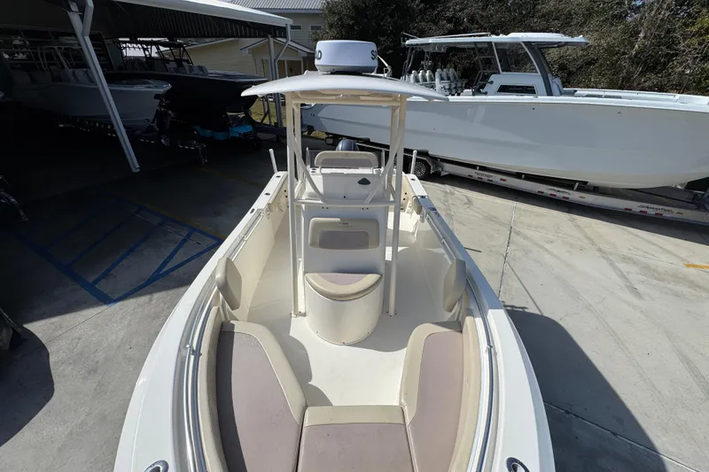 Slide: The Image of 2017 Cobia 220 Center Console boat in storage, showcasing spacious deck and seating. - 21