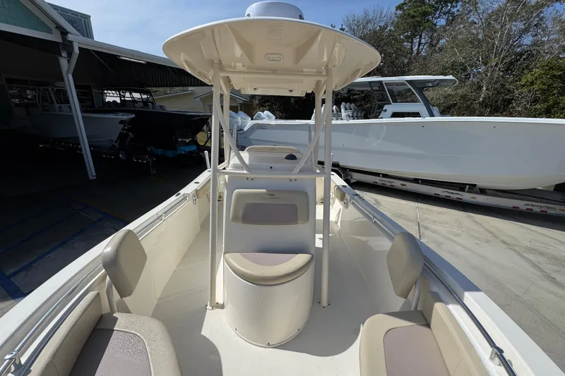 Slide: The Image of 2017 Cobia 220 Center Console boat with seating, parked outdoors. - 22