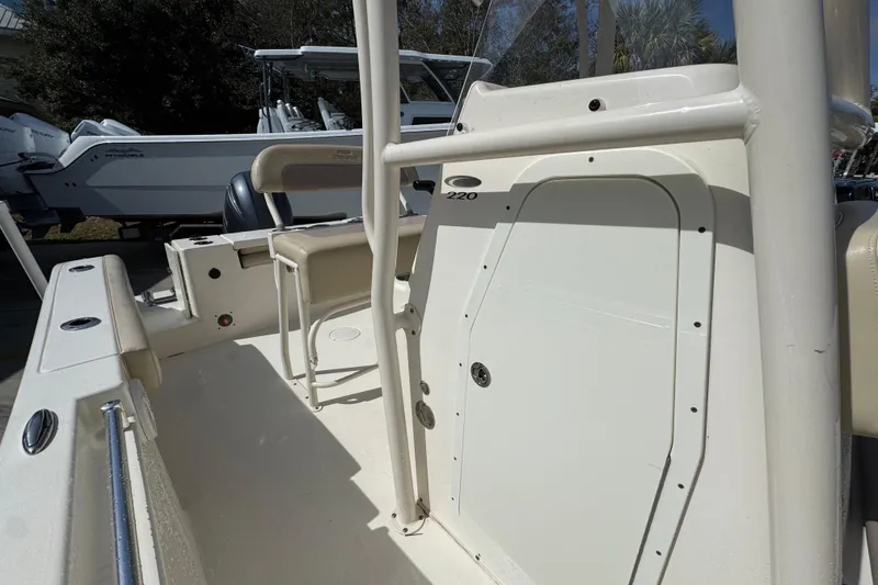 Slide: The Image of 2017 Cobia 220 Center Console boat interior with seating and storage compartment. - 24