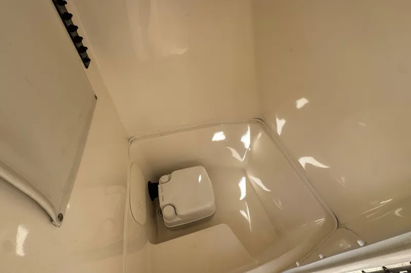 Slide: The Image of 2017 Cobia 220 Center Console boat storage compartment interior view. - 25