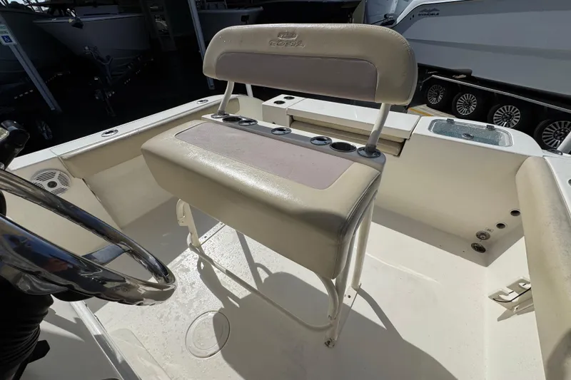 Slide: The Image of 2017 Cobia 220 Center Console boat interior with steering wheel and seating. - 27