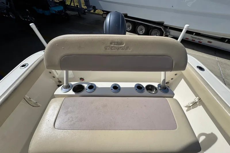 Slide: The Image of 2017 Cobia 220 Center Console boat seat with rod holders and cup holders. - 28