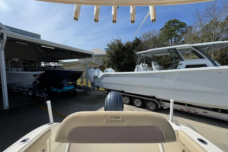 Slide: The Image of 2017 Cobia 220 Center Console boat in storage with other vessels. - 29