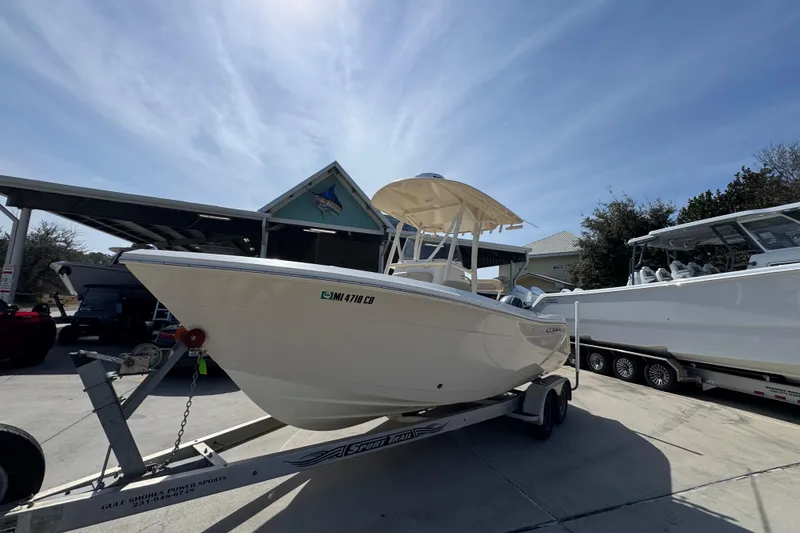 Slide: The Image of 2017 Cobia 220 Center Console boat on trailer under clear sky. - 3