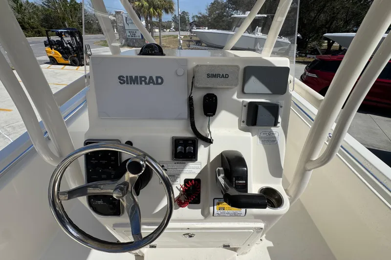 Slide: The Image of 2017 Cobia 220 Center Console boat dashboard with Simrad electronics and Yamaha controls. - 31
