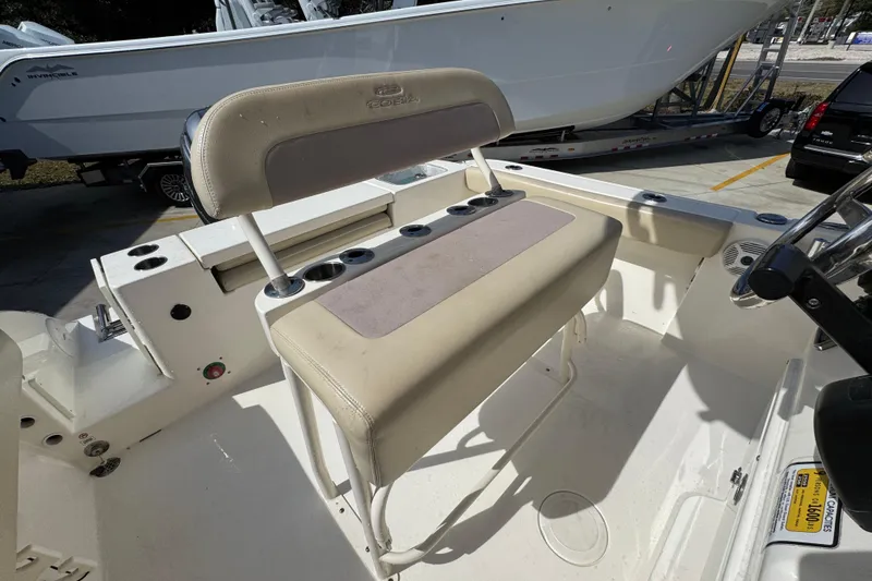 Slide: The Image of 2017 Cobia 220 Center Console boat interior with seating and cup holders. - 34