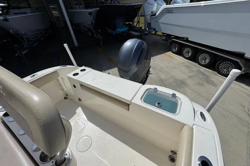 Slide: The Image of 2017 Cobia 220 Center Console boat interior with motor and storage compartments. - 37