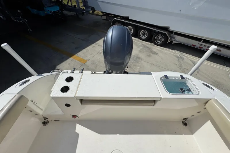 Slide: The Image of 2017 Cobia 220 Center Console boat with motor and fishing rod holders. - 38