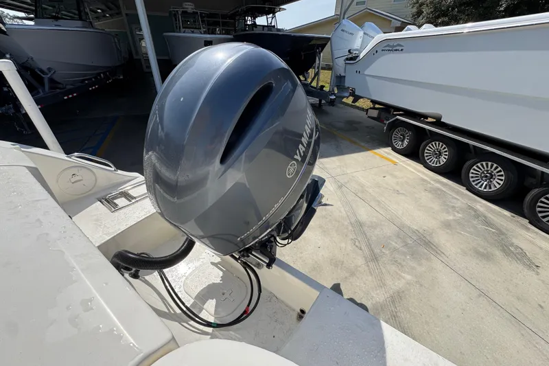 Slide: The Image of 2017 Cobia 220 Center Console with Yamaha outboard motor in a boatyard. - 40