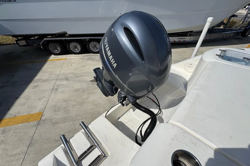 Slide: The Image of 2017 Cobia 220 Center Console with Yamaha outboard motor in a marina setting. - 41