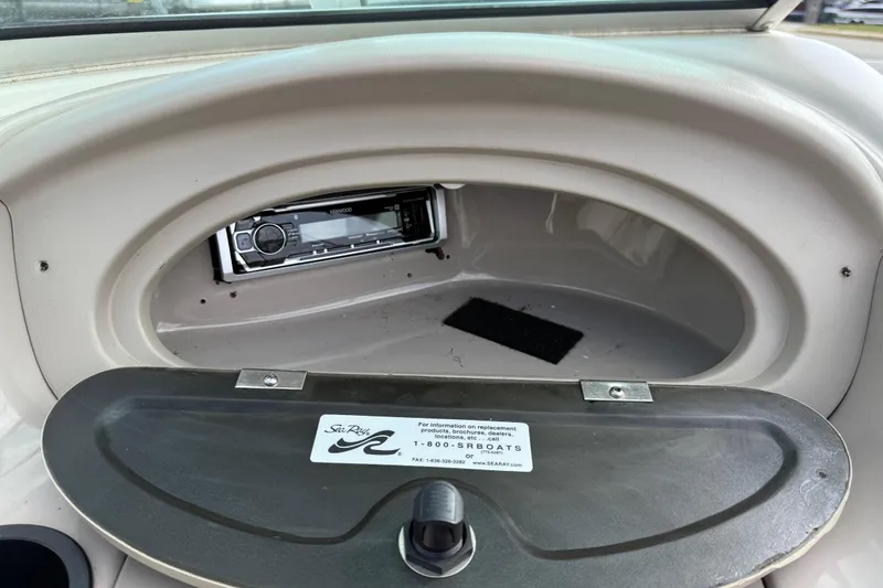 Slide: The Image of 2003 Sea Ray 185 Bow Rider glove compartment with Kenwood stereo system. - 12