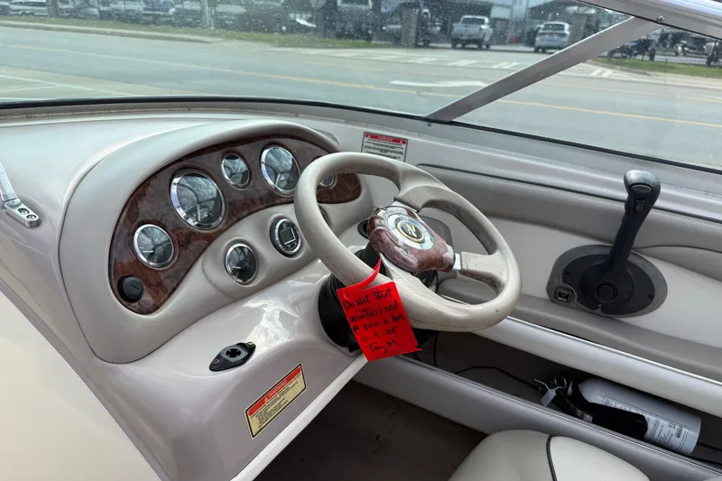 Slide: The Image of 2003 Sea Ray 185 Bow Rider dashboard with steering wheel and instrument panel. - 13