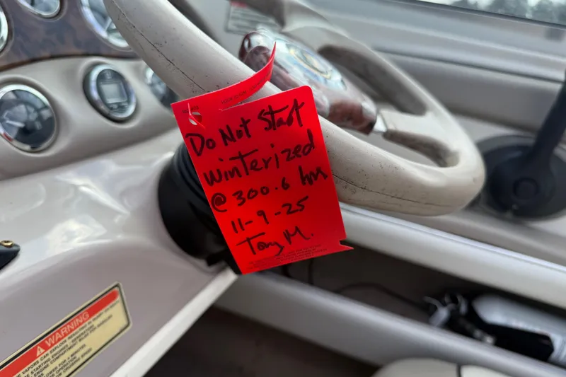 Slide: The Image of 2003 Sea Ray 185 Bow Rider steering wheel with winterization warning tag. - 14