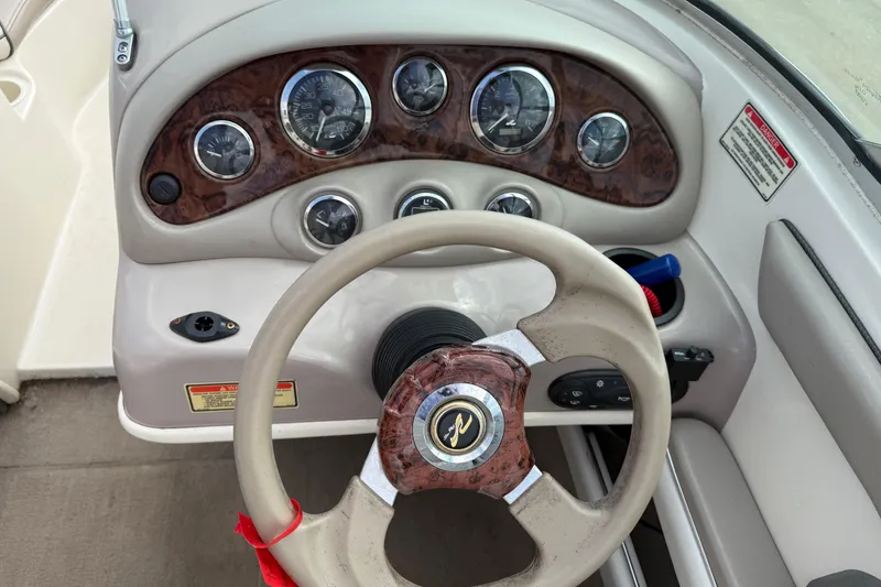 Slide: The Image of 2003 Sea Ray 185 Bow Rider dashboard with steering wheel and instrument panel. - 15