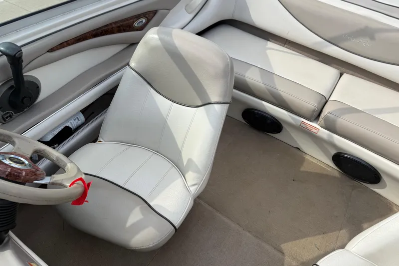 Slide: The Image of Interior of a 2003 Sea Ray 185 Bow Rider boat with beige seating. - 18