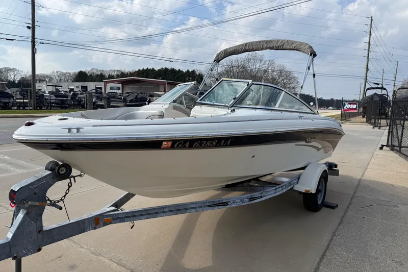 Slide: The Image of 2003 Sea Ray 185 Bow Rider boat on trailer, parked outdoors. - 3