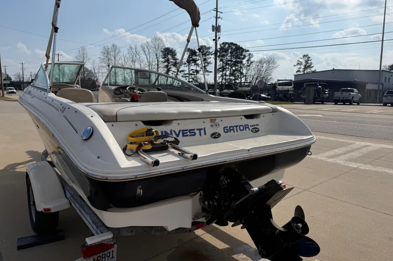 Slide: The Image of 2003 Sea Ray 185 Bow Rider boat on trailer, parked outdoors on a sunny day. - 5