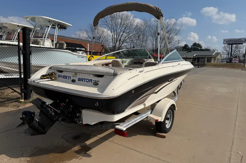 Slide: The Image of 2003 Sea Ray 185 Bow Rider boat on trailer, parked outdoors under a clear sky. - 6